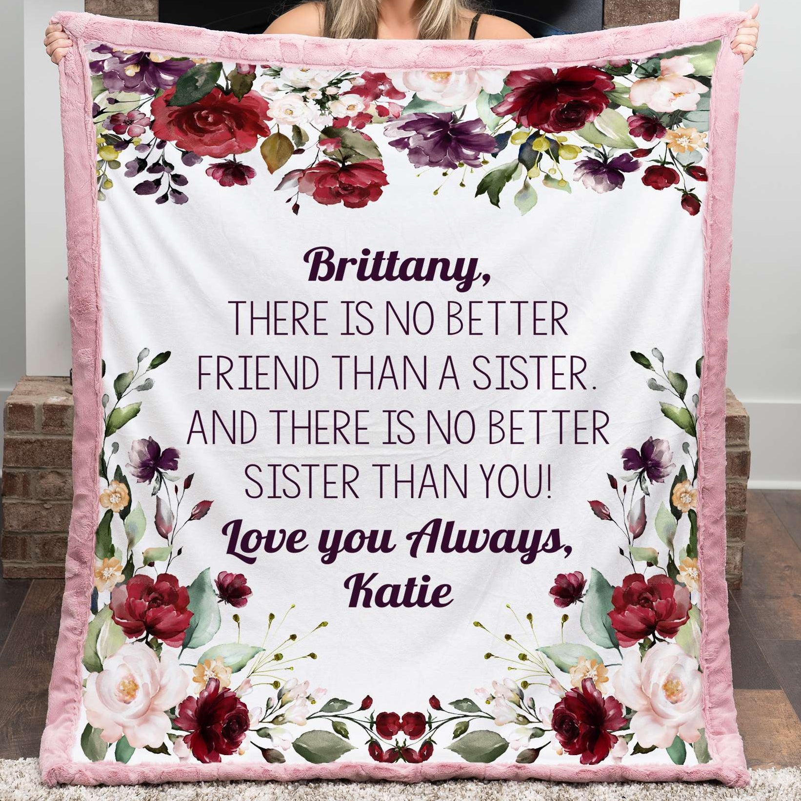 Person holding a floral blanket with personalized text