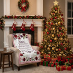 Decorated Christmas living room with a tree, fireplace, and personalized blanket.