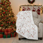 Decorated living room with Christmas tree, stockings, and patterned blanket.