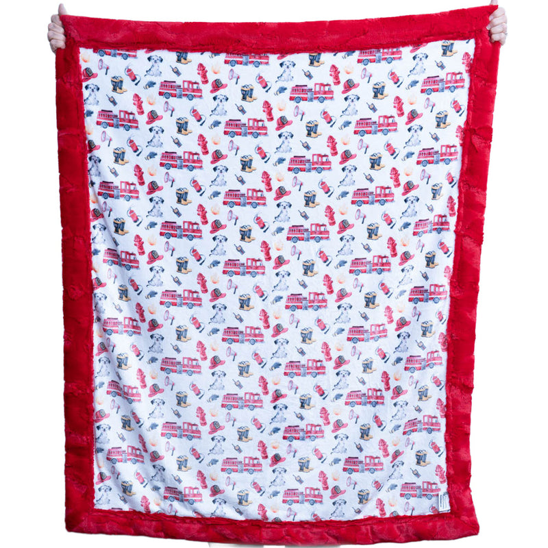 Children's blanket with fire truck and dog pattern on a white background