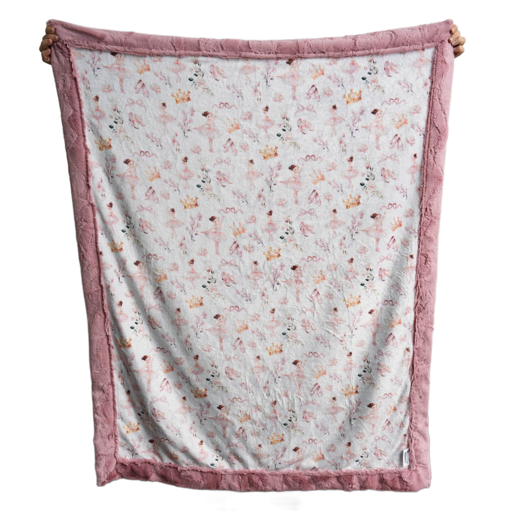 Floral patterned blanket with pink border on a white background