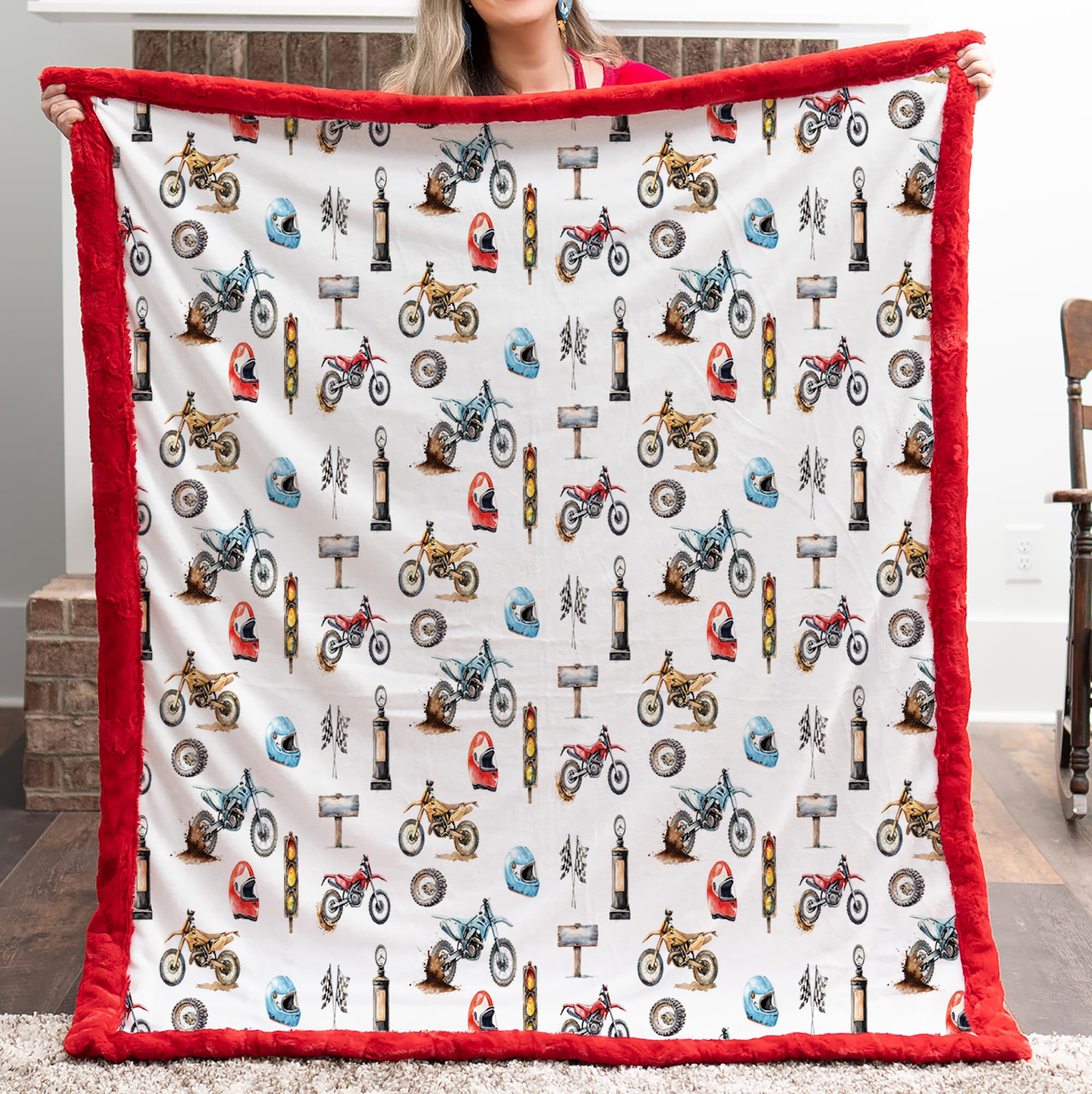Person holding a blanket with motorcycle pattern and red border