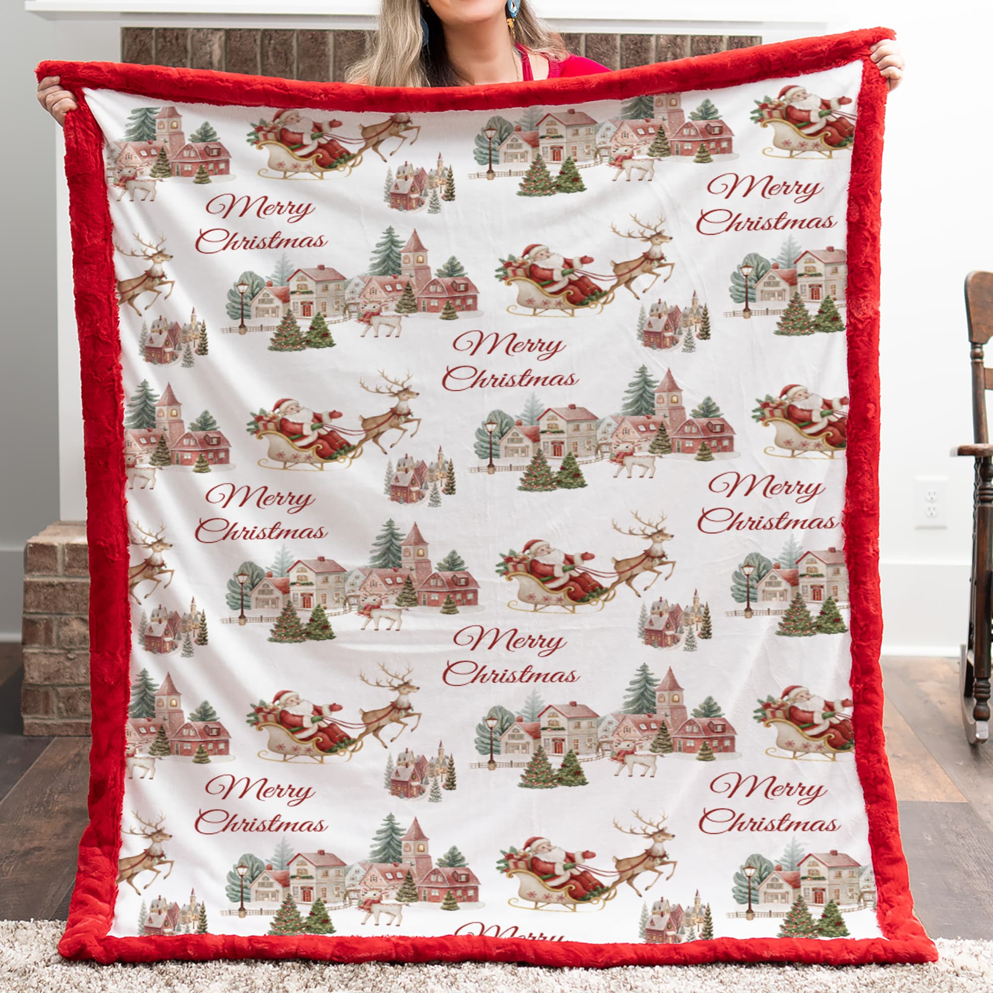 Christmas-themed blanket with red border held by a person indoors.