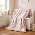 Pink floral ballet minky blanket displayed on a wooden nursery toy chest