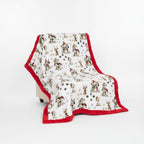 Blanket with dog pattern and red border on a white background