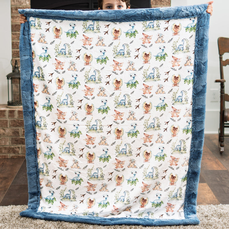 Person holding a blanket with animal pattern in a room with a brick wall and wooden chair.