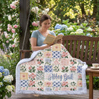 Woman reading on an outdoor porch swing wrapped in a personalized floral minky blanket