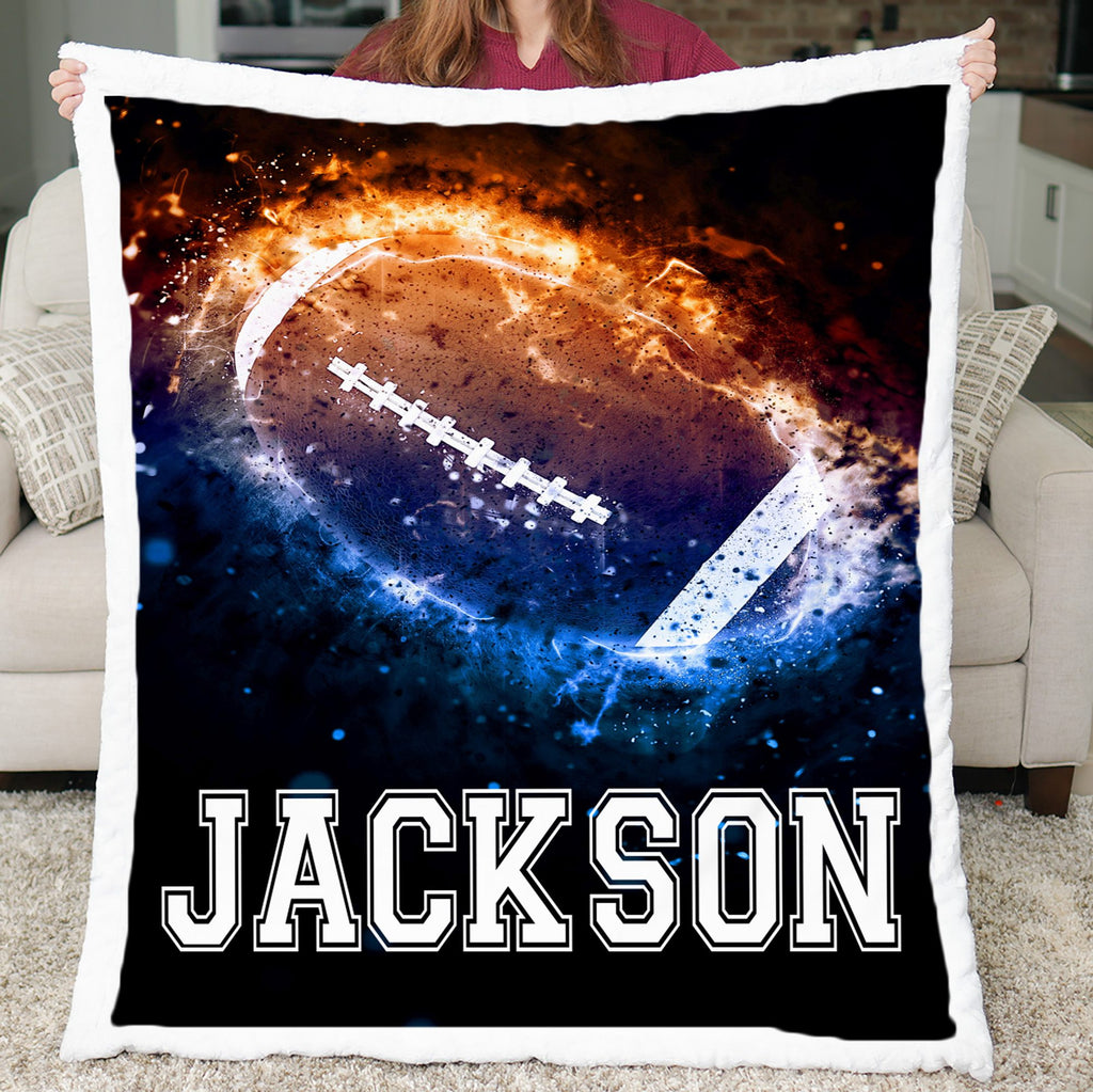 Person holding a blanket with a football design and the name 'Jackson' on it.
