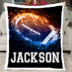 Person holding a blanket with a football design and the name 'Jackson' on it.