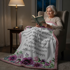 Woman reading a book on a floral blanket with personalized text in a cozy room.