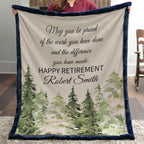 Person holding a retirement gift blanket with a scenic design and text.