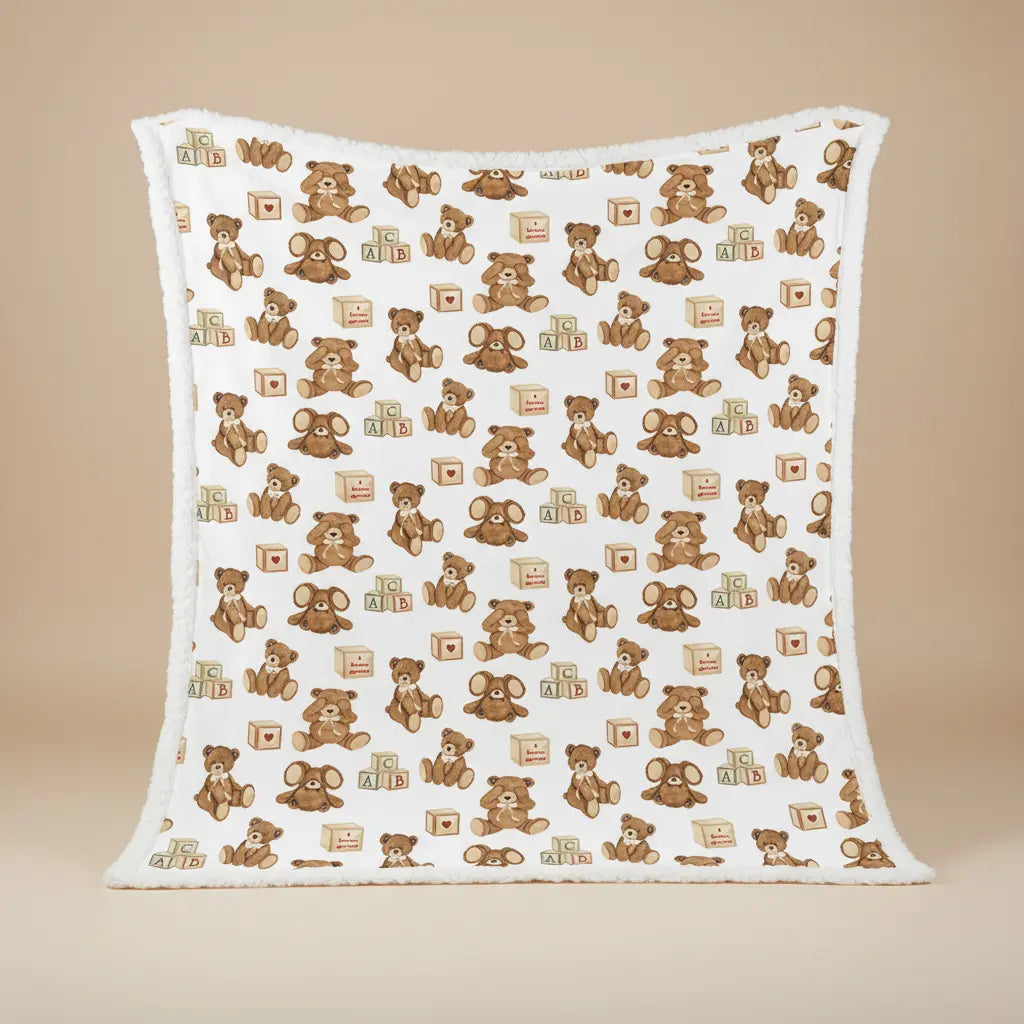 Baby blanket with teddy bear and block pattern on a beige background