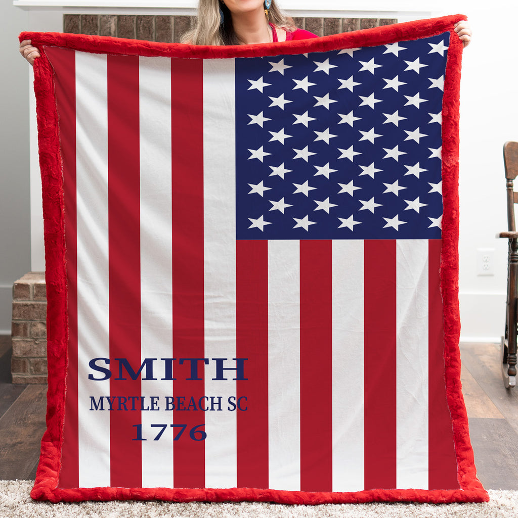Close-up of woman holding personalized American flag blanket with red sherpa trim