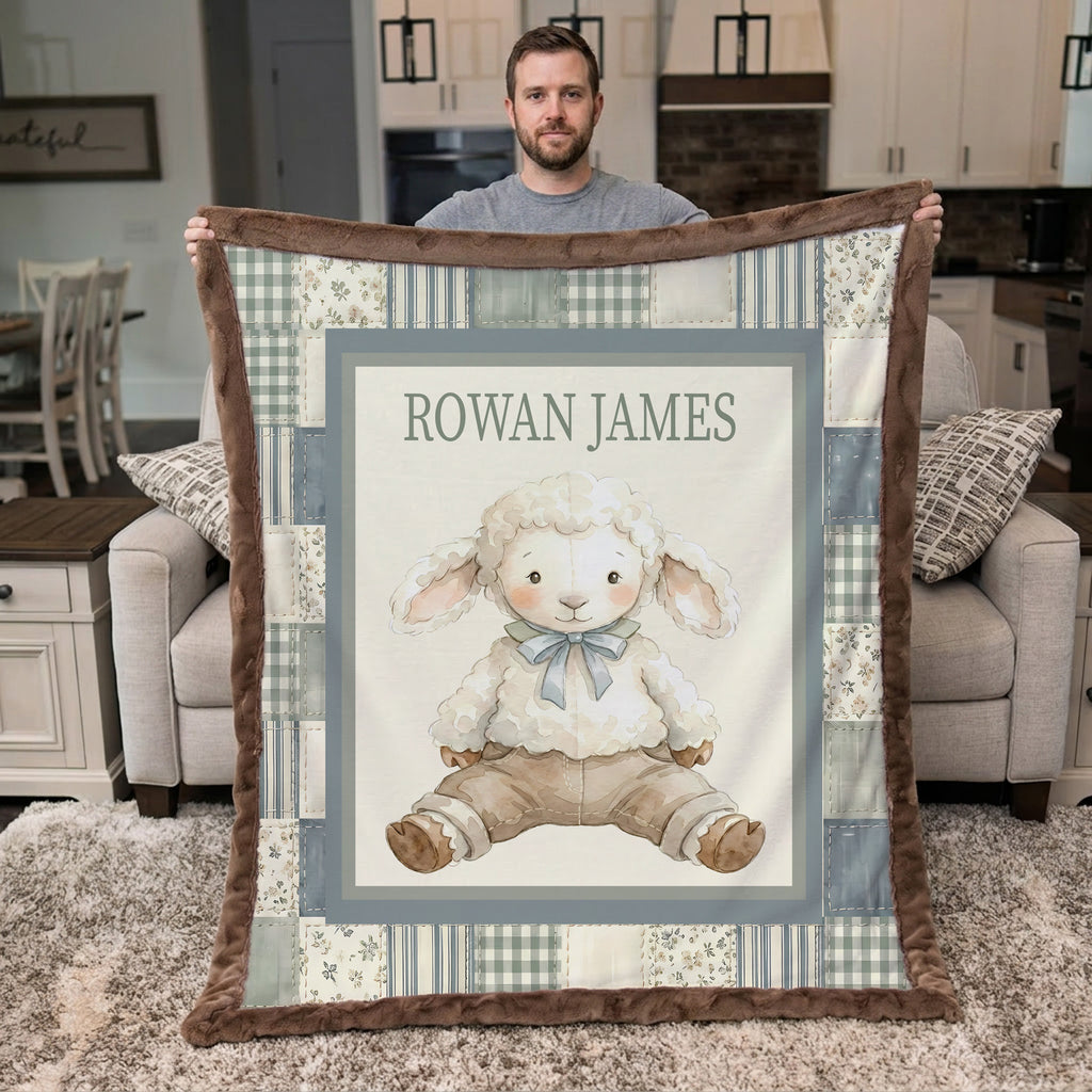 A man holds up a personalized patchwork-style baby blanket featuring a cartoon sheep illustration and the name 'ROWAN JAMES' in a real living room setting.