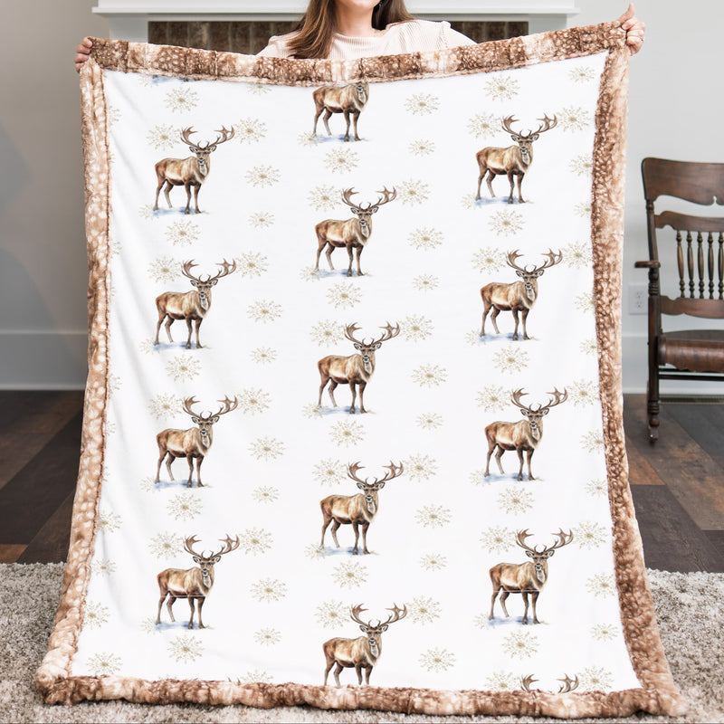 Woman holding a large blanket with deer pattern in a living room.