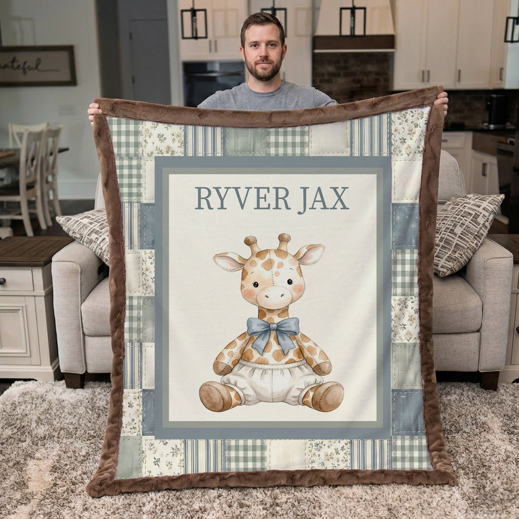 A man holds up a personalized baby blanket in a living room setting. The blanket features a central illustration of a cute baby giraffe wearing a blue bow tie, surrounded by a patchwork border of blue plaid, floral, and brown faux fur trim.