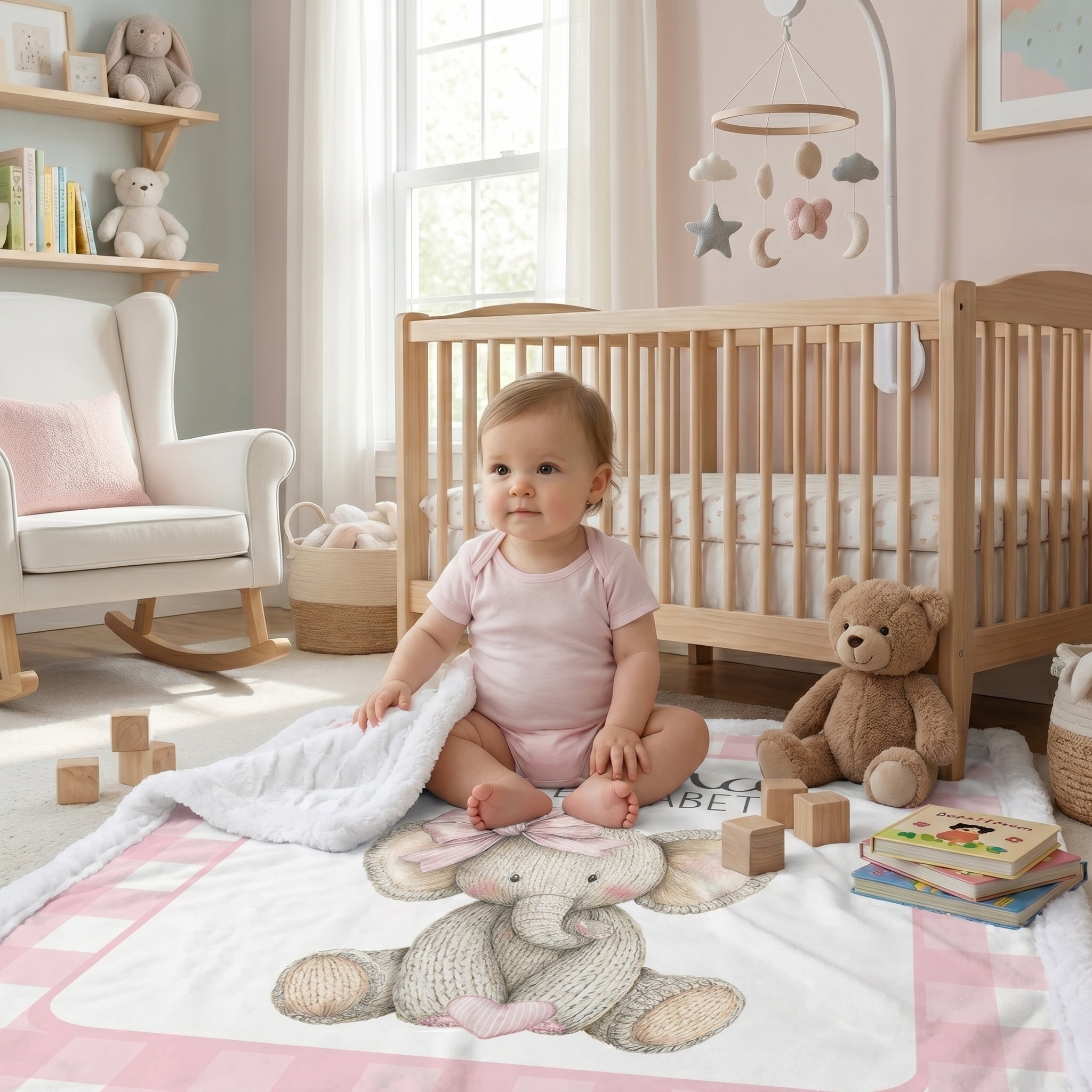 Baby sitting on personalized elephant minky blanket in front of nursery crib