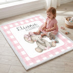 Baby sitting on personalized elephant minky blanket by window with toys