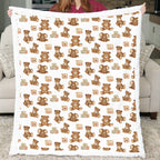 Person holding a blanket with teddy bear and elephant pattern in a living room.