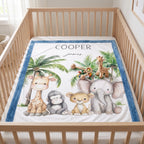 A personalized baby bedding set featuring a plush blanket with a colorful safari animal illustration and a matching blue and white fitted sheet, displayed inside a light wood crib.