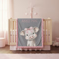 Personalized pig minky baby blanket displayed on wooden crib rail in pink girl nursery