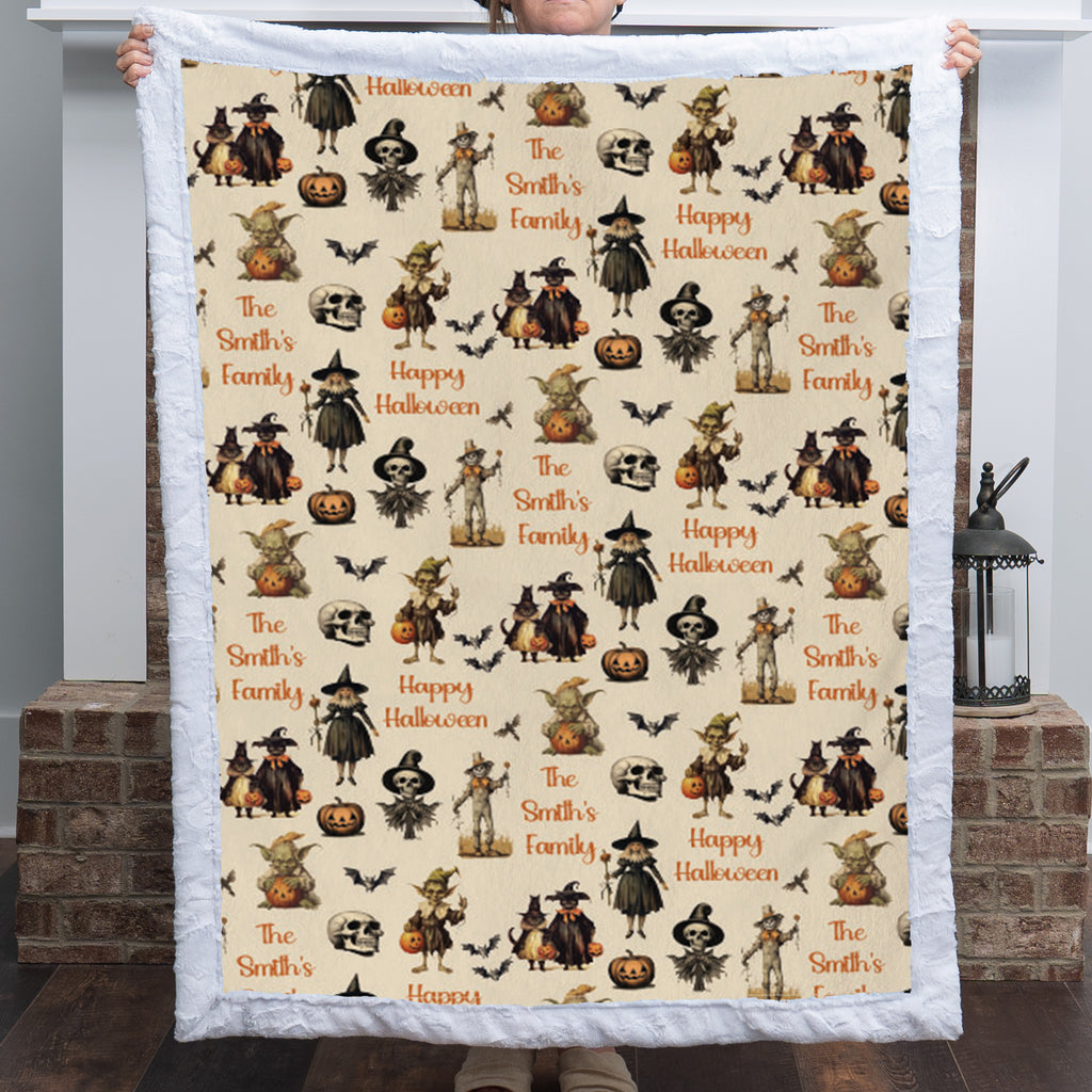 Custom name Halloween throw blanket held up, vintage witches and skeleton print, white sherpa back