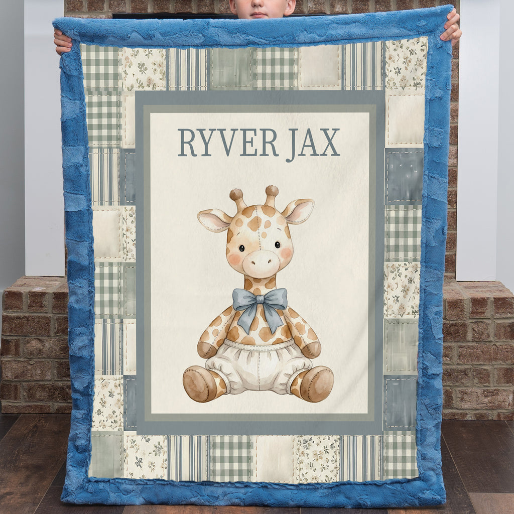 A personalized baby quilt held up by a child, featuring a central illustration of a sitting giraffe wearing a blue bow tie, surrounded by a patchwork border and a blue plush border. The center reads 'RYVER JAX'.