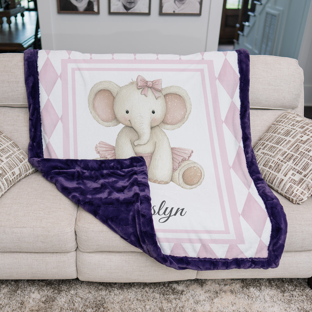 Elephant minky baby blanket on couch, folded to show plum minky backing