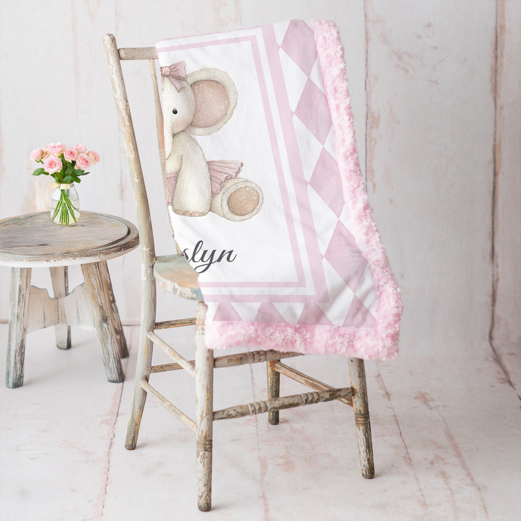 Elephant minky baby blanket draped over rustic chair, rosette fur backing visible