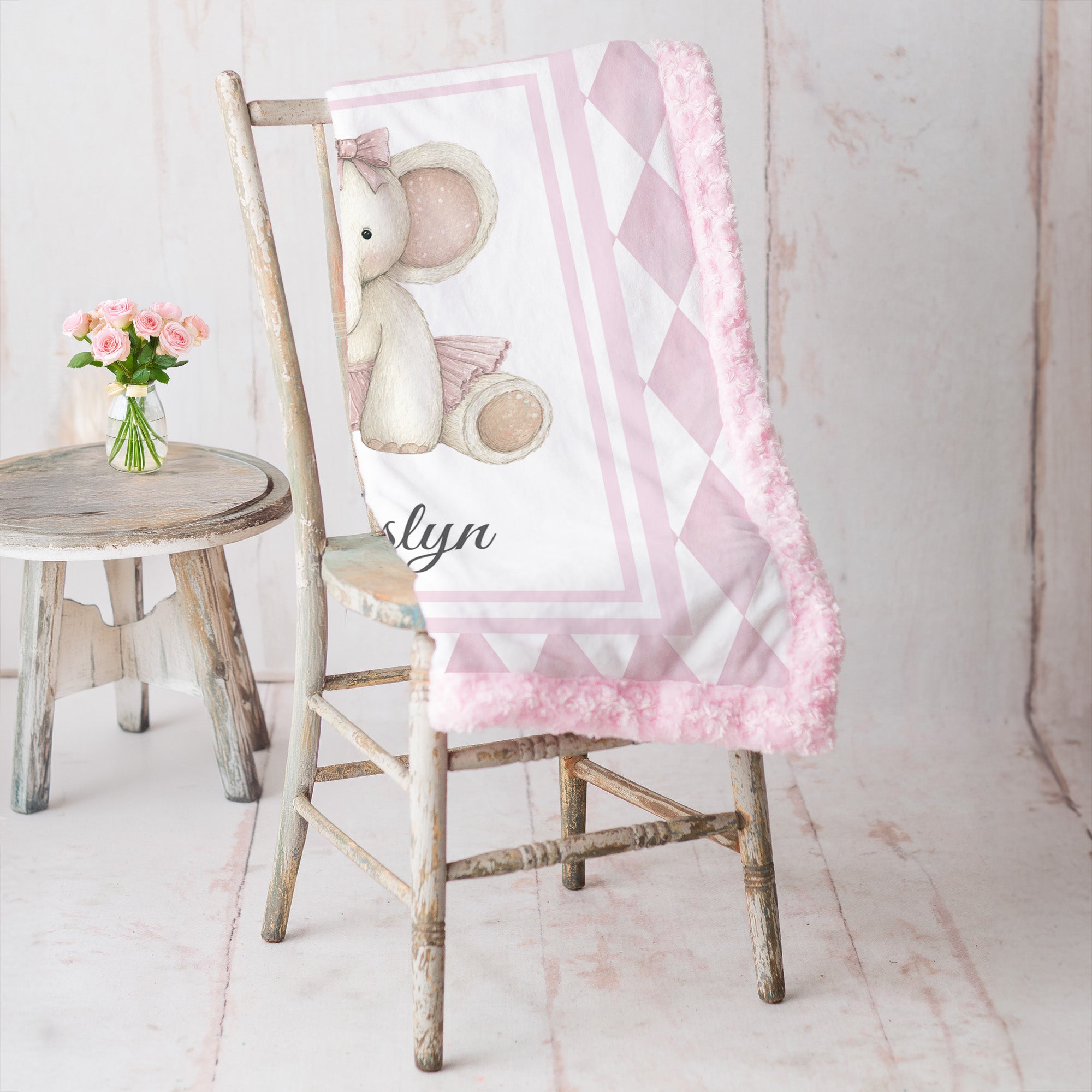 Elephant minky baby blanket draped over rustic chair, rosette fur backing visible