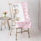 Elephant minky baby blanket draped over rustic chair, pink rosette fur backing