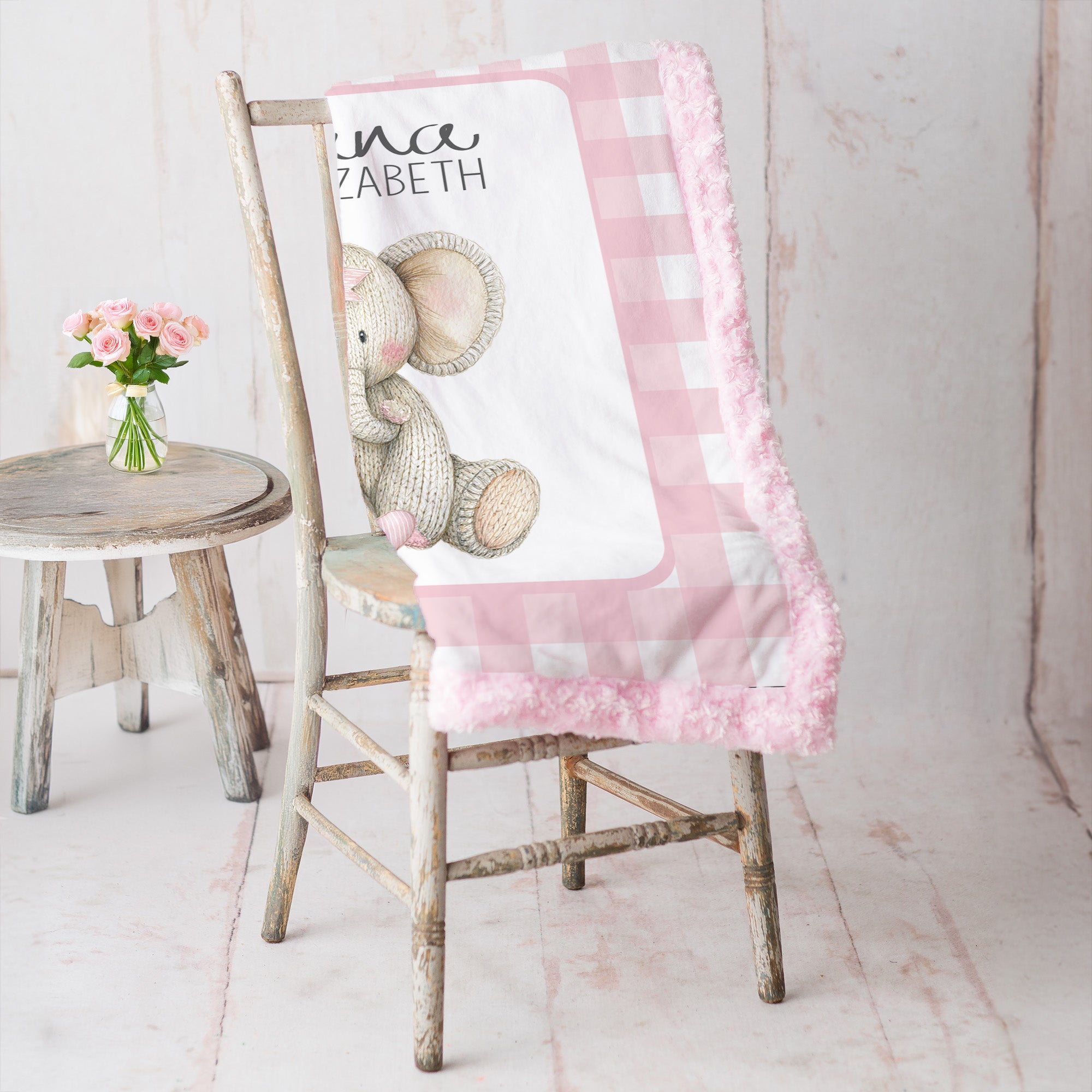 Elephant minky baby blanket draped over rustic chair, pink rosette fur backing