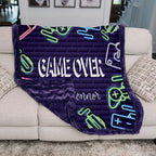 Neon-themed blanket with 'GAME OVER' text draped over a couch.