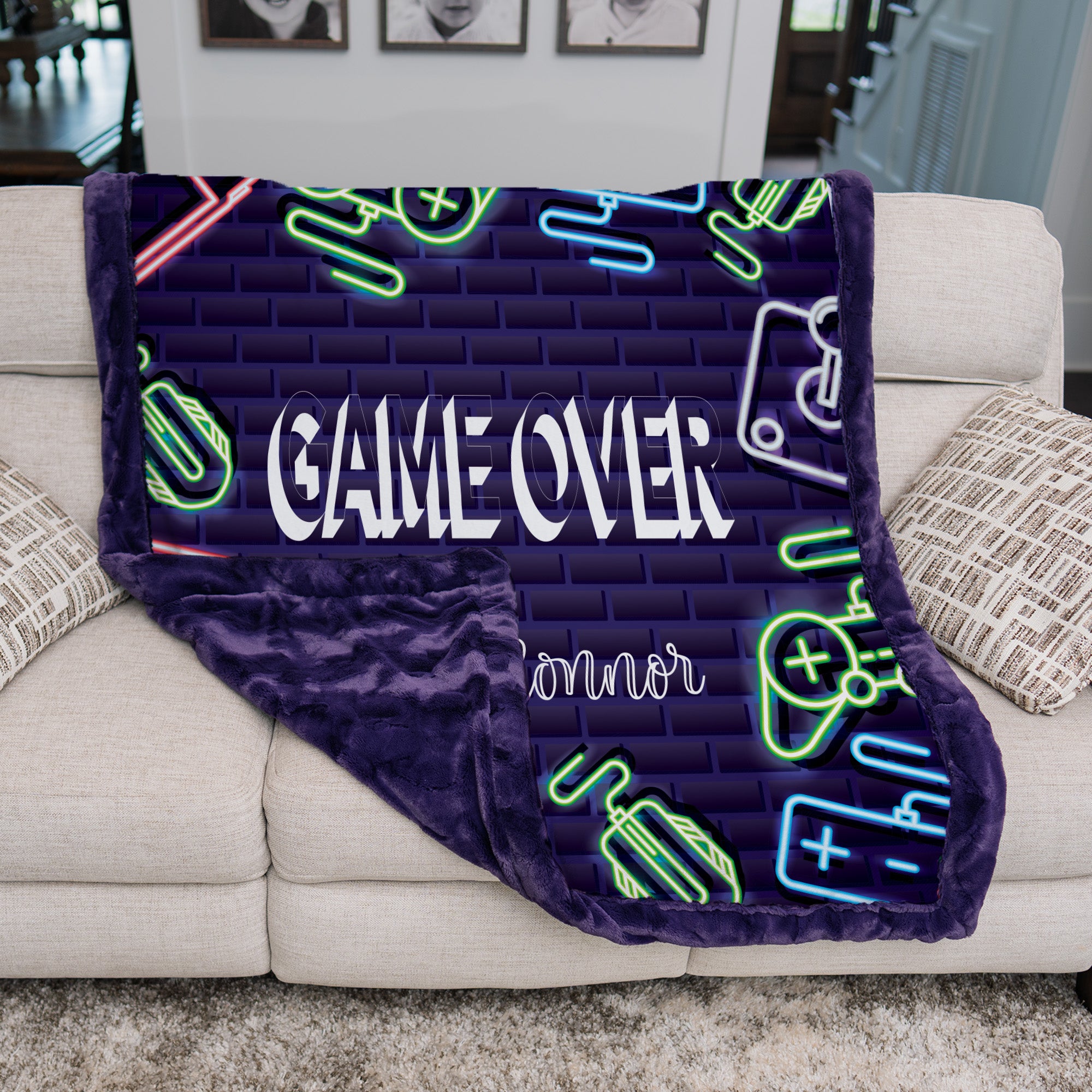 Neon-themed blanket with 'GAME OVER' text draped over a couch.