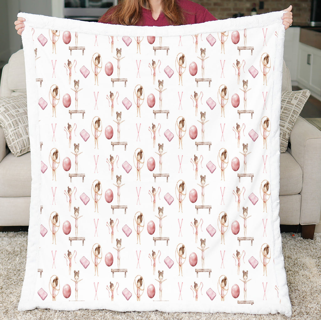 Person holding a blanket with a pattern of ballerinas and eggs.