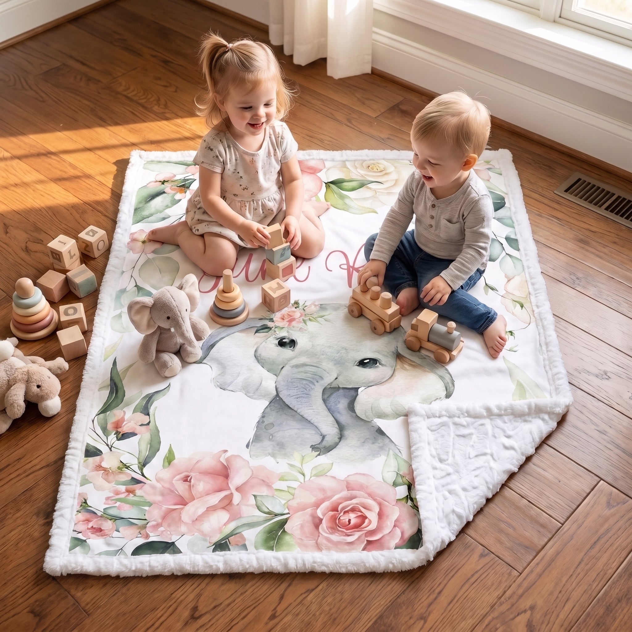 Two toddlers playing with wooden toys on floral elephant minky baby blanket