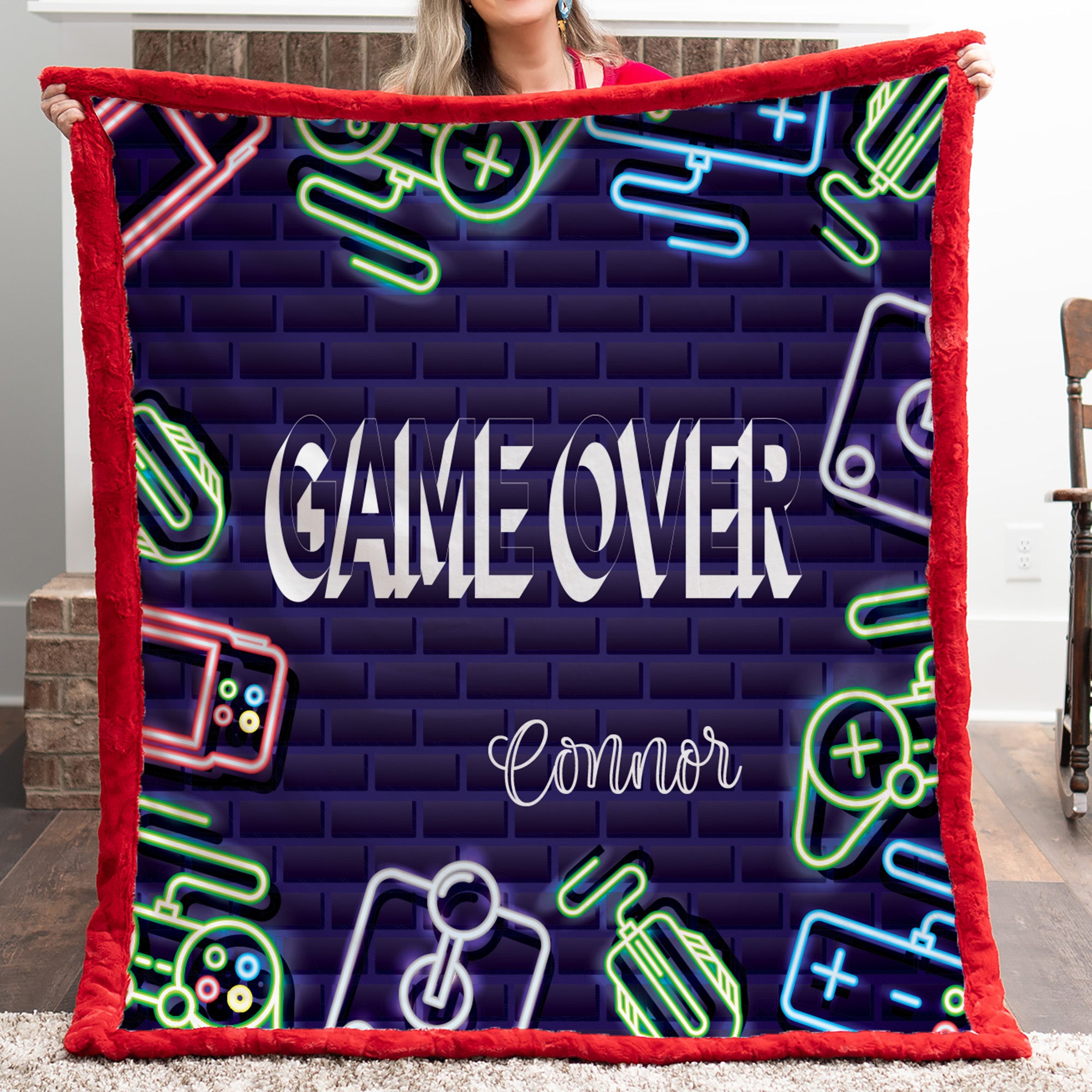 Person holding a blanket with 'Game Over' and neon graphics design.