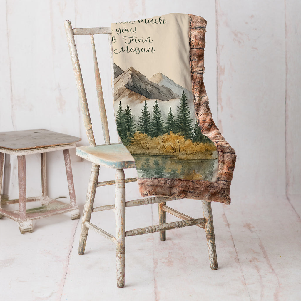 The blanket is folded sitting on a. chair.