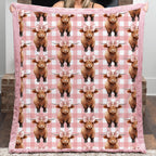 Person holding a pink blanket with Highland cow pattern