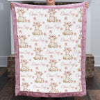 Personalized highland cow minky baby blanket with dusty pink fur trim, held up by fireplace