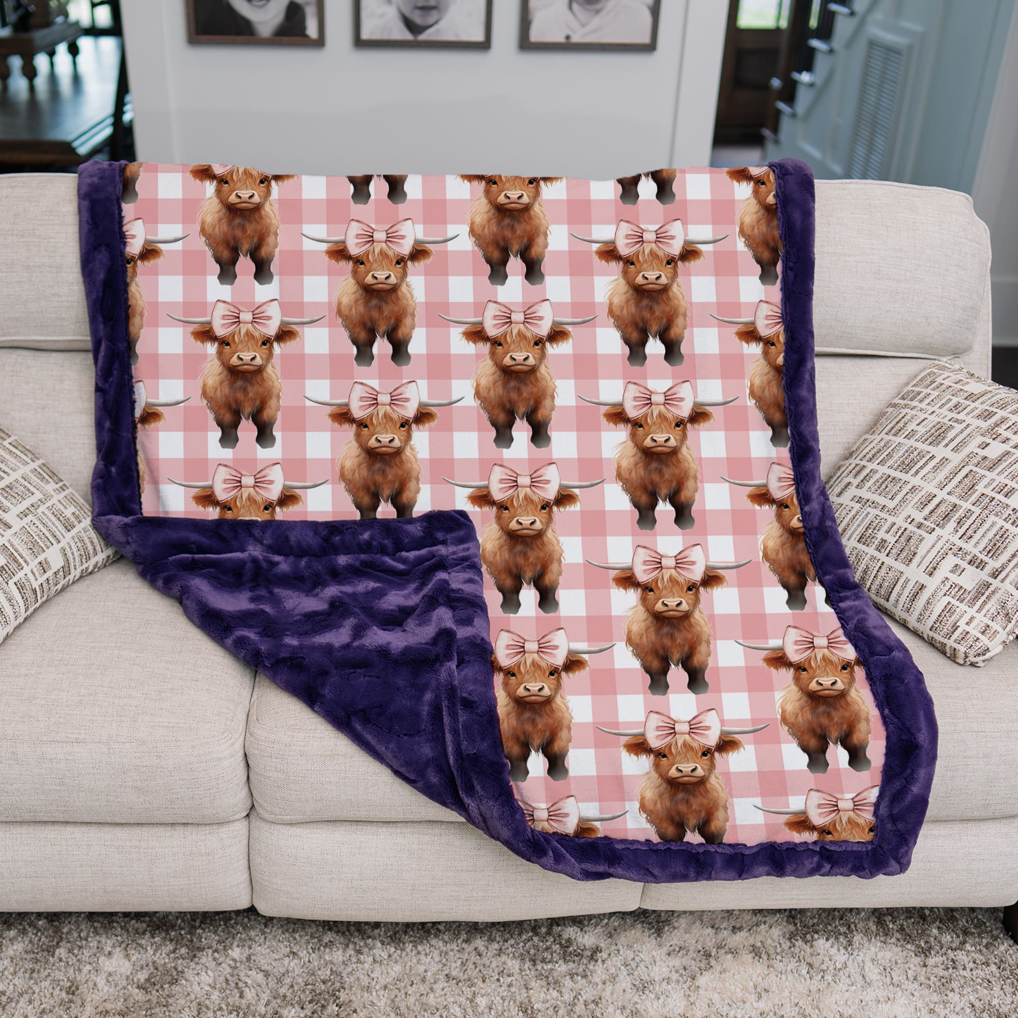 Blanket with highland cow pattern draped over a sofa