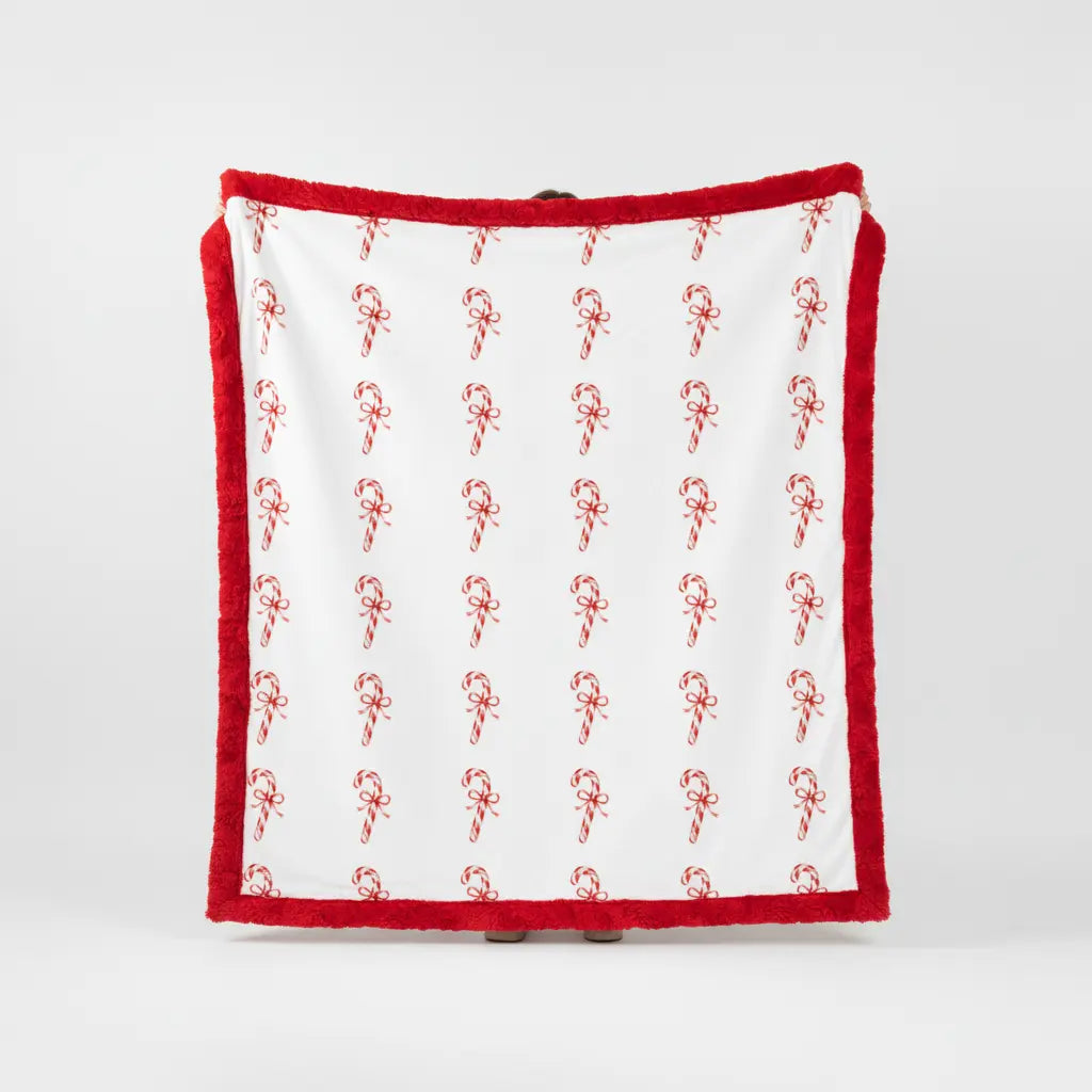 White towel with red candy cane pattern on a white background