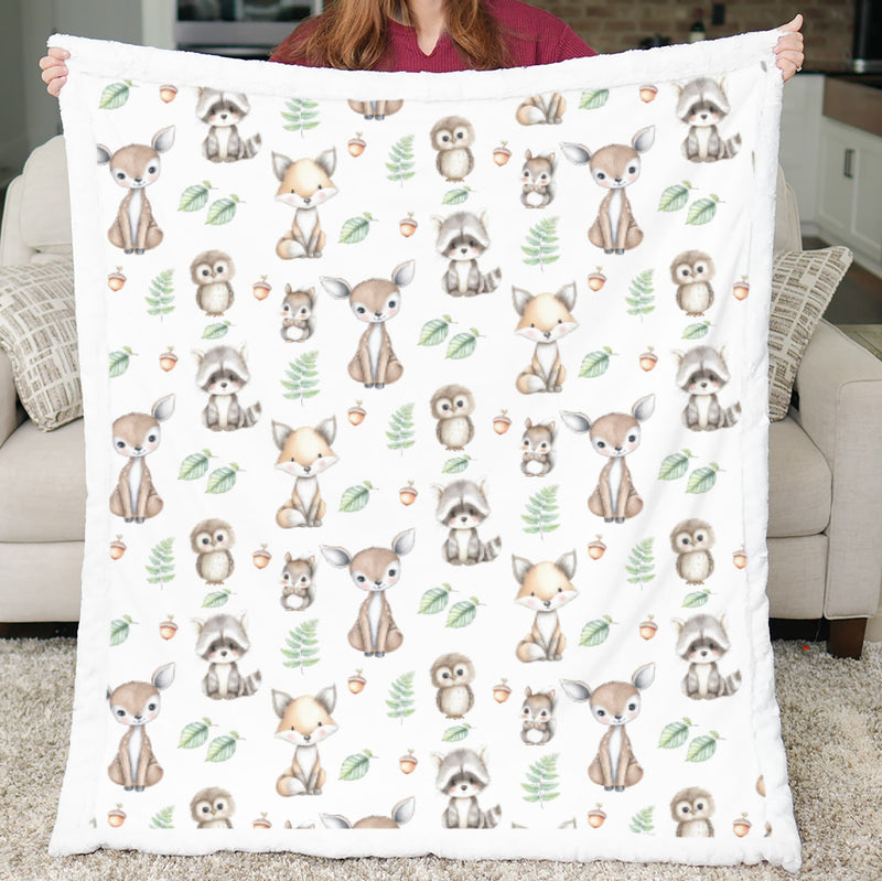 Person holding a blanket with forest animal pattern in a living room.
