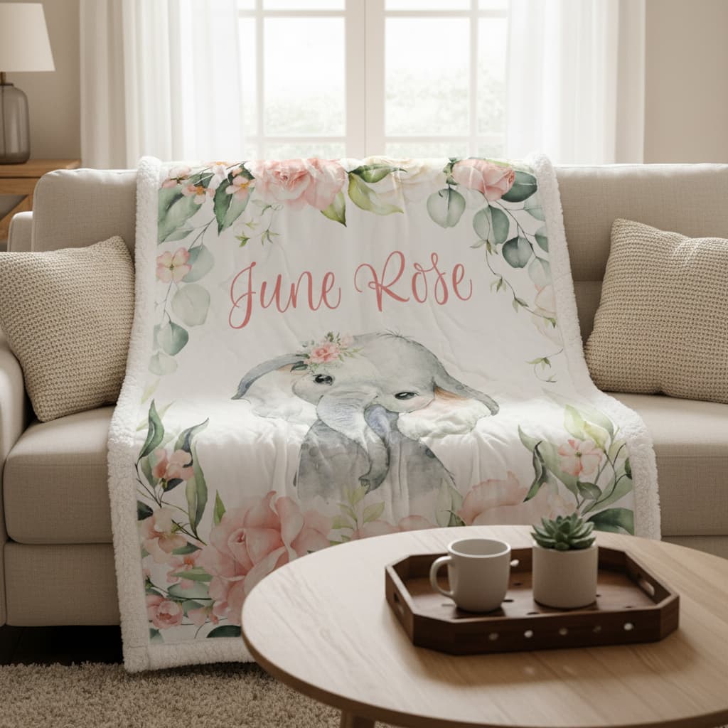 Floral blanket with 'June Rose' text on a couch in a living room setting.