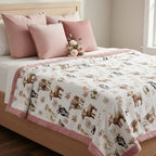 Bed with animal print comforter and pink pillows in a bedroom setting