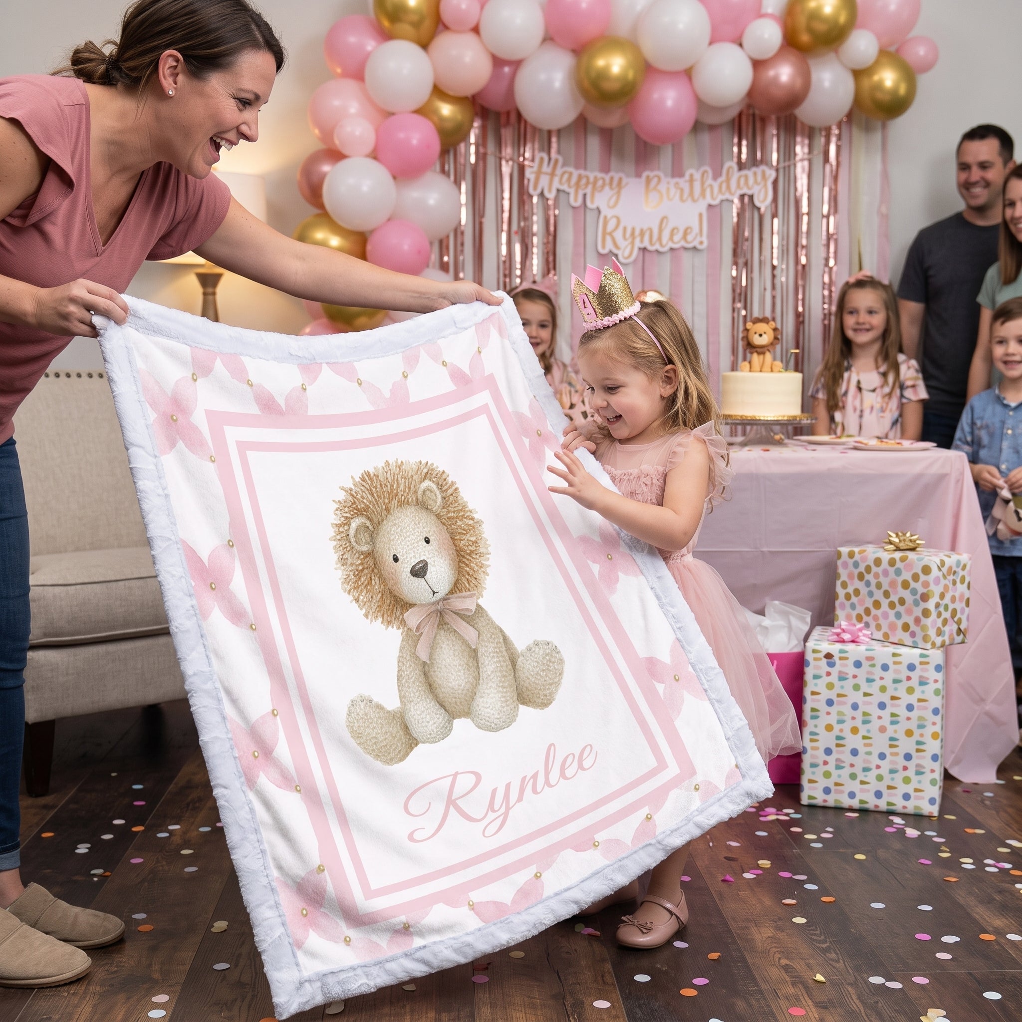 Woman gifting personalized lion minky blanket to girl at pink and gold birthday party