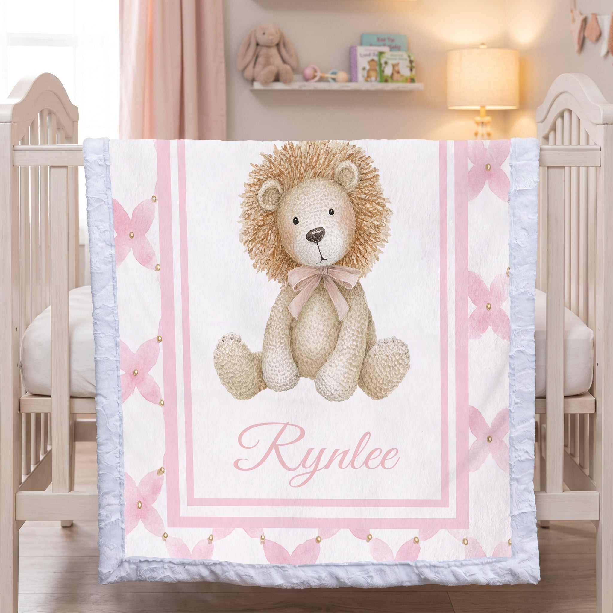 Personalized lion minky baby blanket with white fur trim, hanging on crib in pink nursery