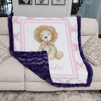 Personalized lion minky baby blanket with plum fur trim, draped over cream couch cushions