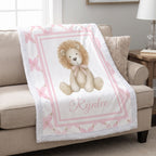 Personalized lion minky baby blanket with white fur trim, draped over cream armchair