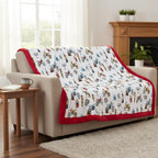 Sofa with a colorful blanket featuring motorcycle designs in a living room setting.